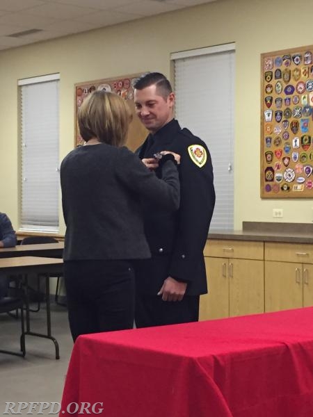 FF/PM Anthony Palkovitz' mother, Susan Elliott, pins his badge on during the Swearing-In ceremony. 01/09/2018